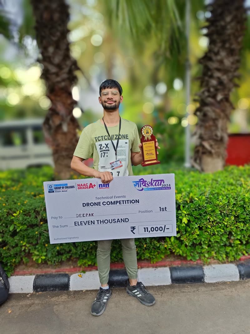Deepak holding the first-place trophy and prize cheque of the Saviskar drone competition