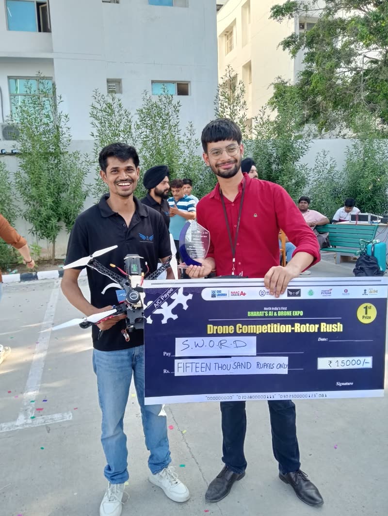 Deepak and teammate with their drone, trophy and first-prize cheque at the Rotor Rush drone competition