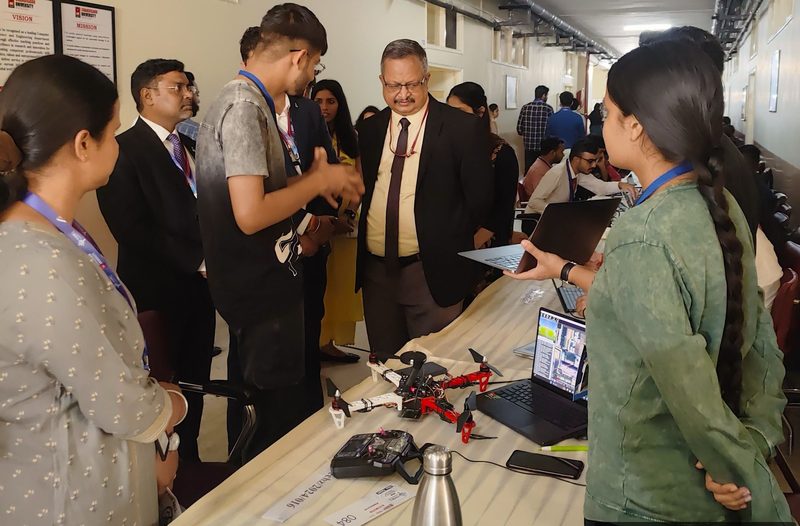 Judges looking at Deepak's drone at the Zeenovato hackathon